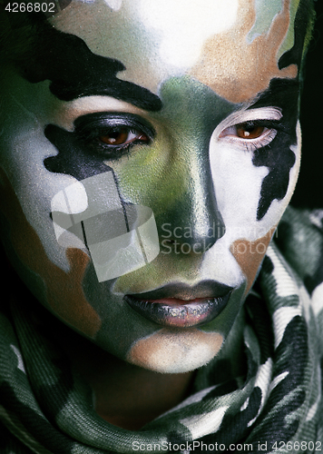 Image of Beautiful young fashion woman with military style clothing and face paint make-up, khaki colored