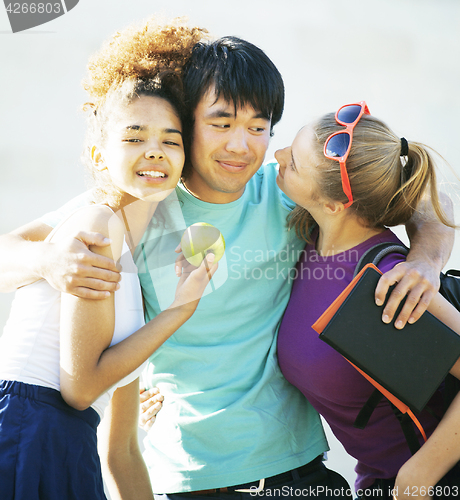 Image of cute group of teenages at the building of university with books huggings