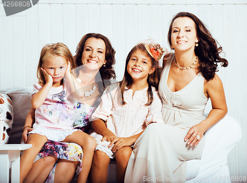 Image of Mature sisters twins at home with little daughter, happy family