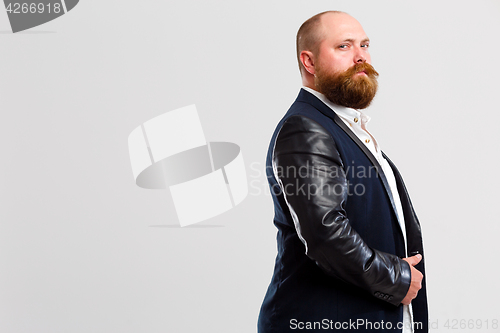 Image of Man with beard stands sideways