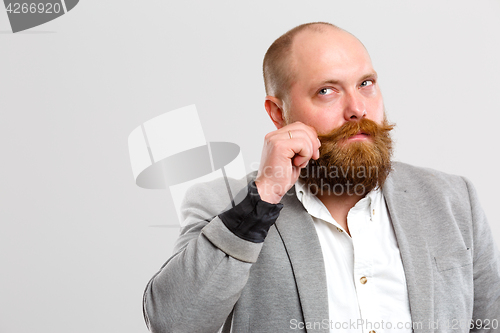 Image of Man with beard clings mustache