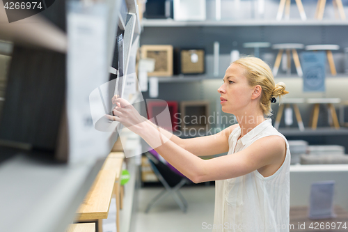 Image of Woman shopping for furniture, sofa and home decor in store.