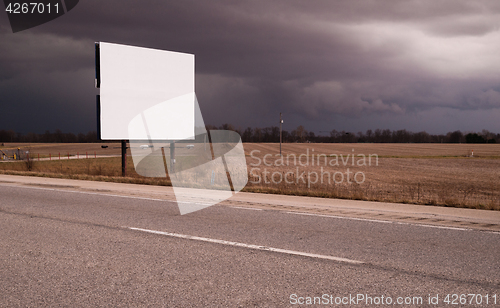 Image of Roadside Billboard Advertising Medium Dark Stormy Skies