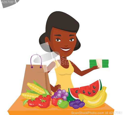 Image of Woman standing at the table with shopping bag.