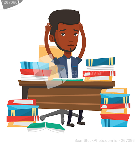 Image of Student sitting at the table with piles of books.