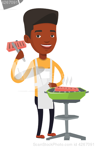 Image of Man cooking steak on barbecue grill.