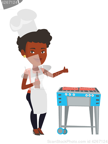 Image of Woman cooking meat on gas barbecue grill.