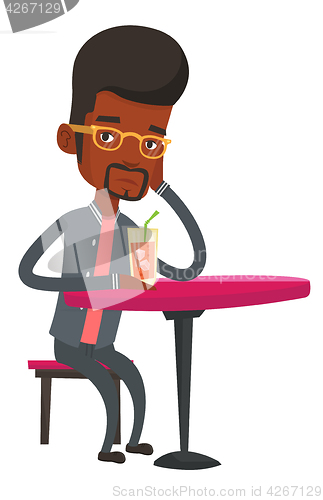 Image of Man drinking cocktail at the bar.