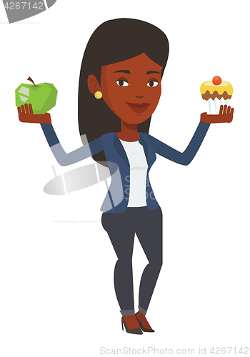 Image of Woman choosing between apple and cupcake.