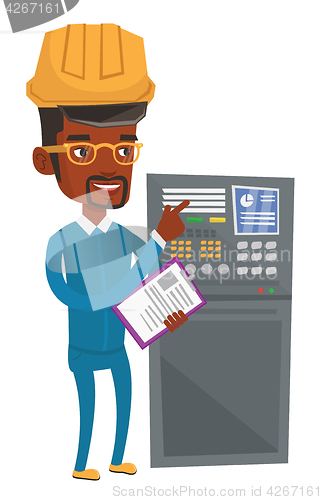 Image of Engineer standing near control panel.