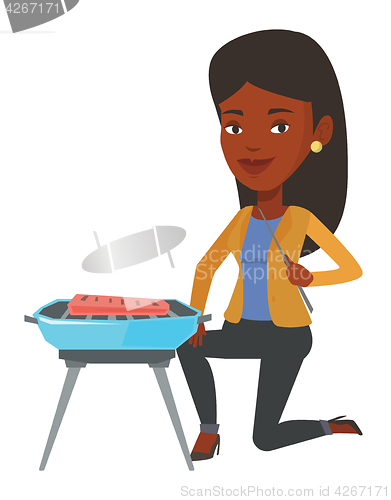 Image of Woman cooking meat on barbecue.