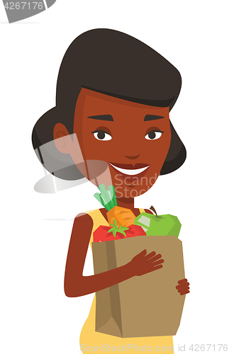 Image of Happy woman holding grocery shopping bag.