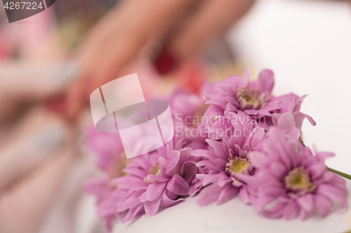 Image of Woman hands receiving a manicure