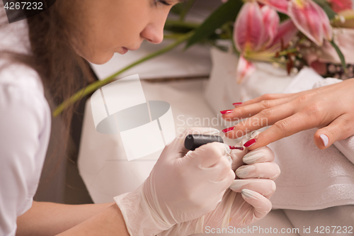 Image of Woman hands receiving a manicure