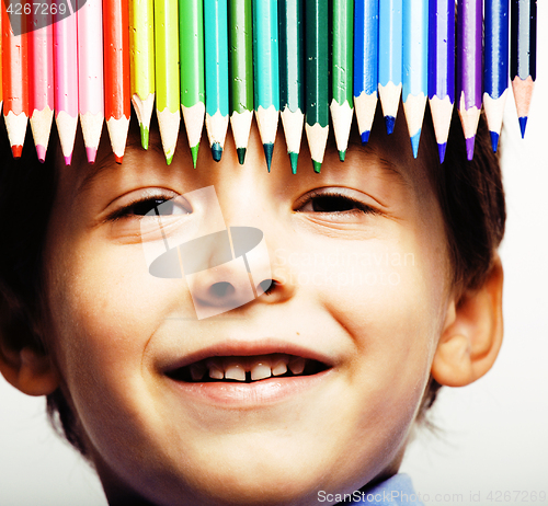 Image of little cute boy with color pencils close up smiling