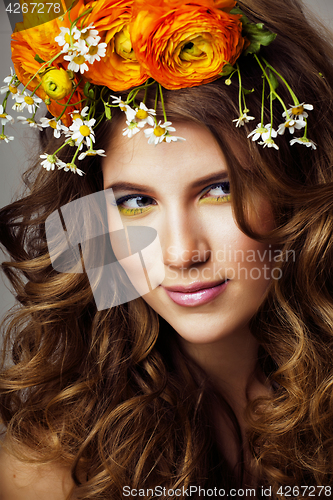 Image of Beauty young woman with flowers and make up close up, real spring beauty