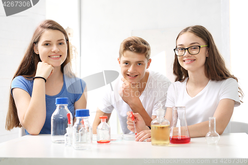 Image of Schoolgirl performs chemical experience.