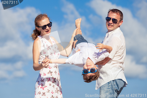 Image of Happy family walking on the beach at the day time.