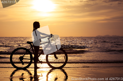 Image of Happy teen girl  walking on the beach