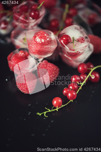 Image of Frozen berries on wooden table