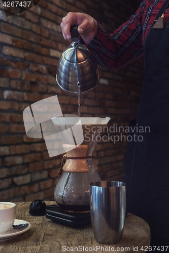 Image of Barista brewing coffee