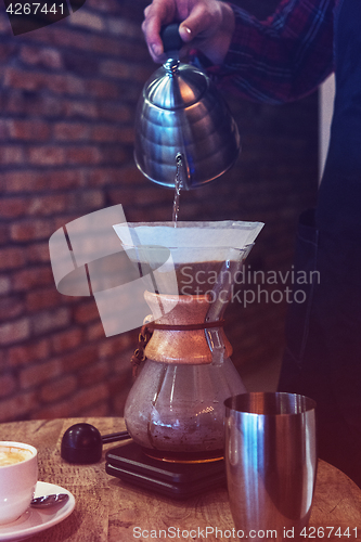 Image of Barista brewing coffee