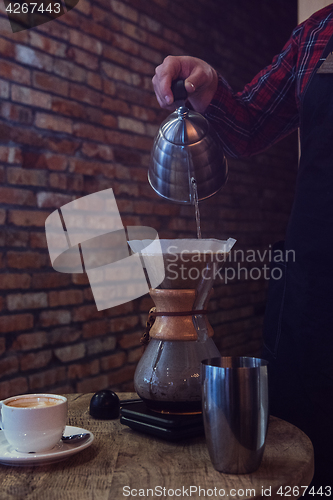 Image of Barista brewing coffee