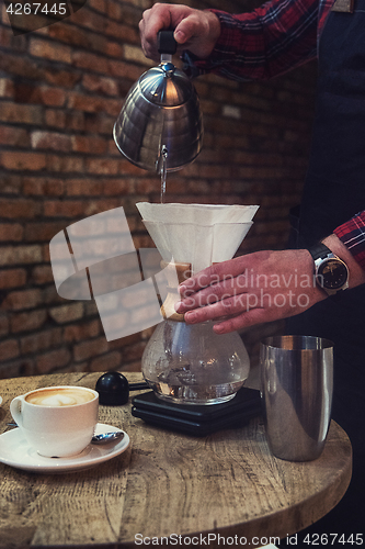 Image of Barista brewing coffee