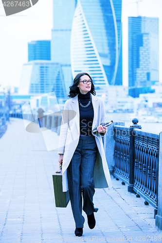 Image of Beautiful woman in a light coat