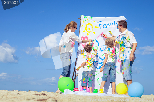 Image of Happy family playing on the beach at the day time.