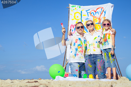 Image of Happy family playing on the beach at the day time.