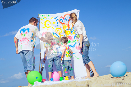 Image of Happy family playing on the beach at the day time.