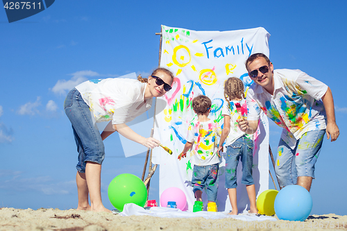 Image of Happy family playing on the beach at the day time.