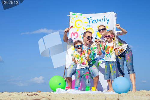 Image of Happy family playing on the beach at the day time.