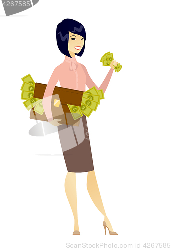 Image of Business woman with briefcase full of money.