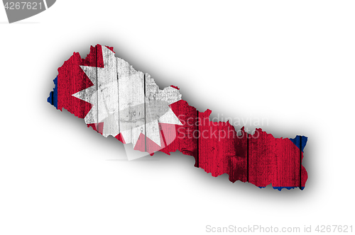 Image of Map and flag of Nepal on weathered wood