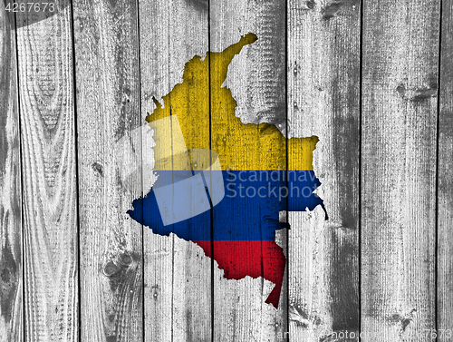 Image of Map and flag of Colombia on weathered wood