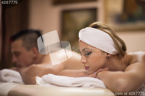 Image of young couple lying on massage table