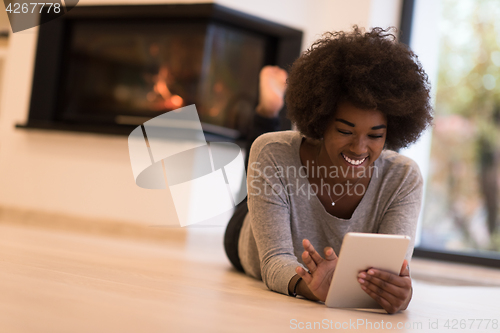 Image of black women using tablet computer on the floor