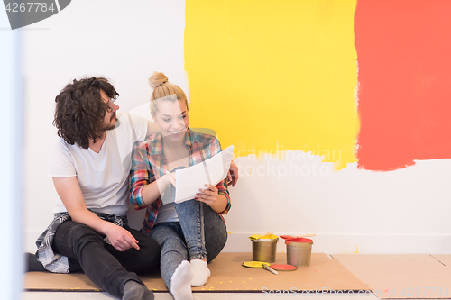 Image of Happy young couple relaxing after painting