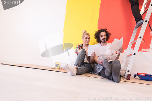 Image of Happy young couple relaxing after painting