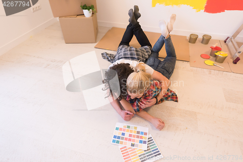 Image of Happy young couple relaxing after painting