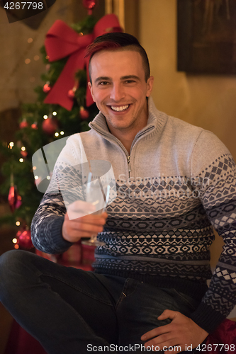 Image of Happy young man with a glass of champagne