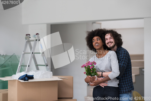 Image of multiethnic couple moving into a new home