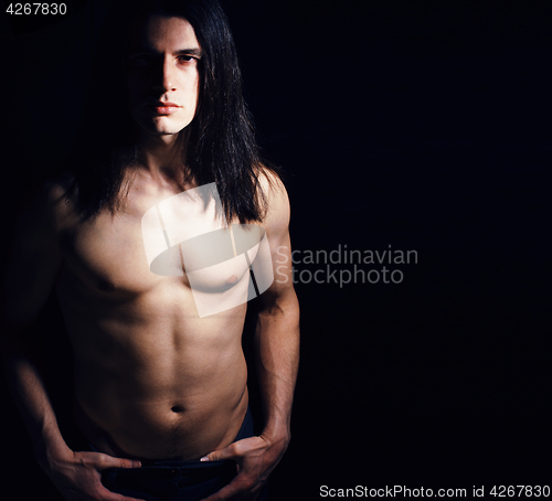 Image of handsome young man with long hair naked torso
