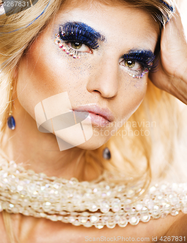 Image of beauty blong woman with shiny creative makeup