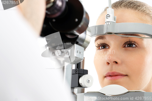 Image of Computer aided visual acuity. The patient during an eye examination at the eye clinic 