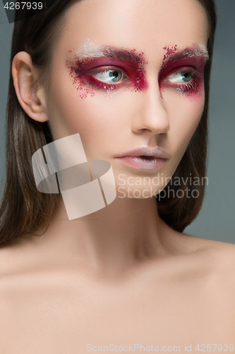 Image of Beautiful woman face portrait close up with red make up