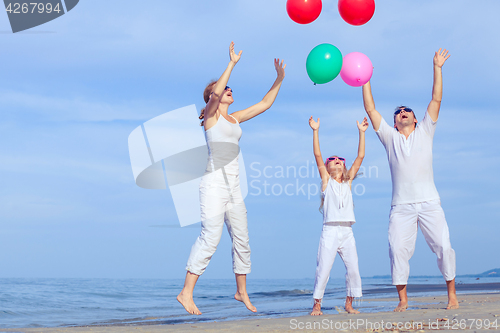 Image of Happy family playing on the beach at the day time.