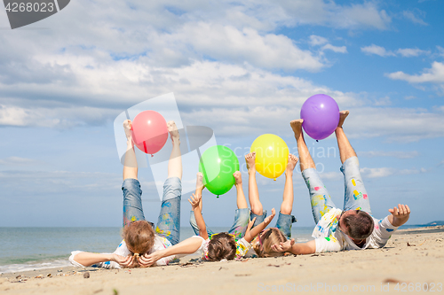 Image of Happy family playing on the beach at the day time.